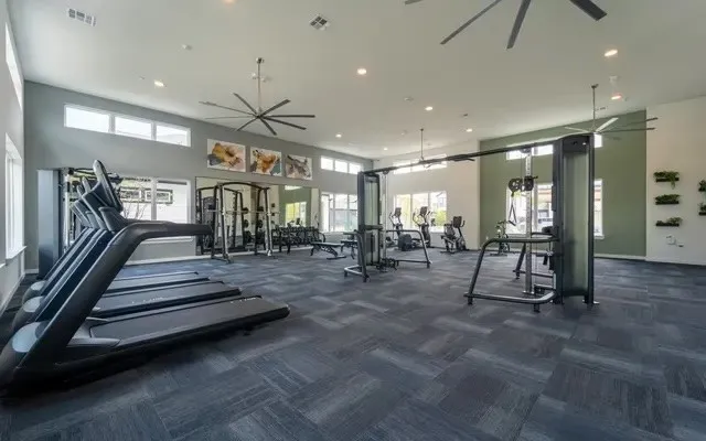 a view of a room with lots of gym equipment