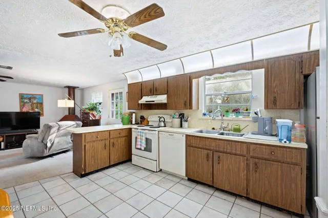 a kitchen with a sink cabinets and window