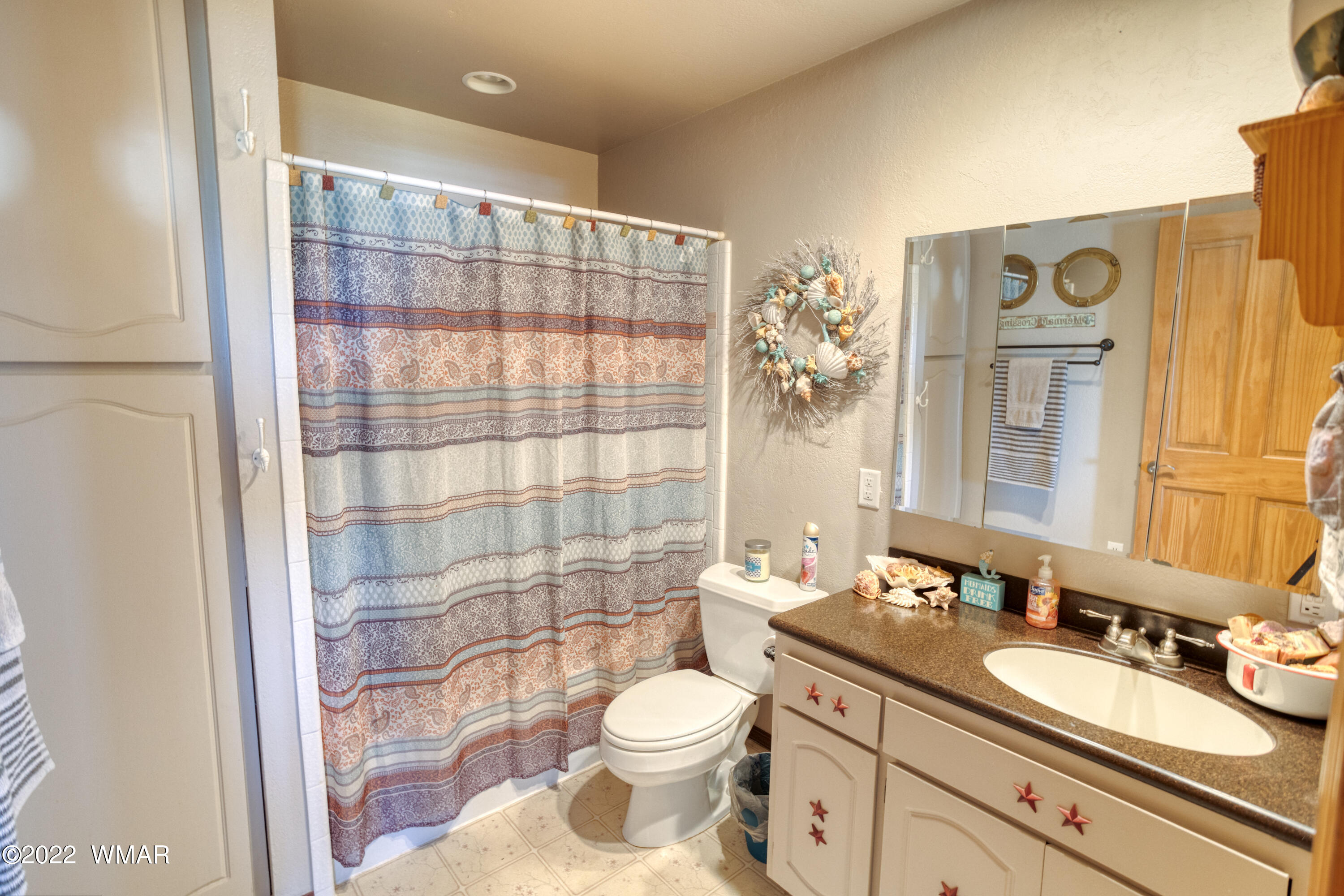 501 West 7th S Street Snowflake, AZ 85937 - Photo 14 of 33 a bathroom with a double vanity sink toilet and shower