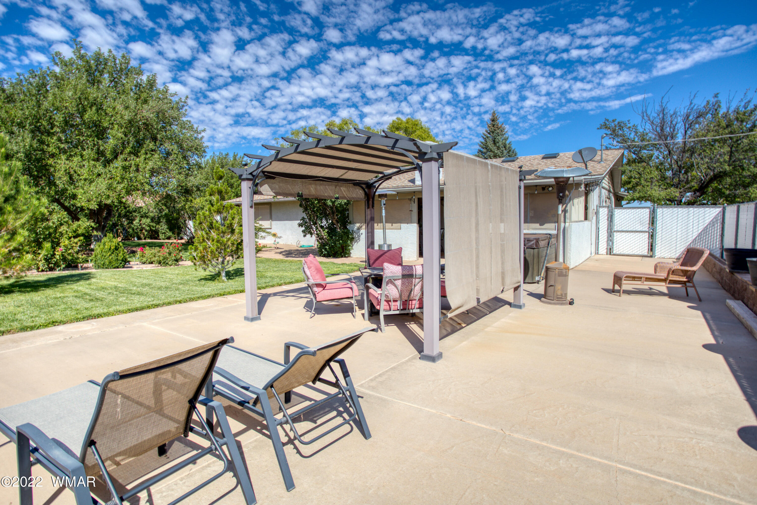 501 West 7th S Street Snowflake, AZ 85937 - Photo 21 of 33 a view of a patio with table and chairs and potted plants with wooden floor and fence