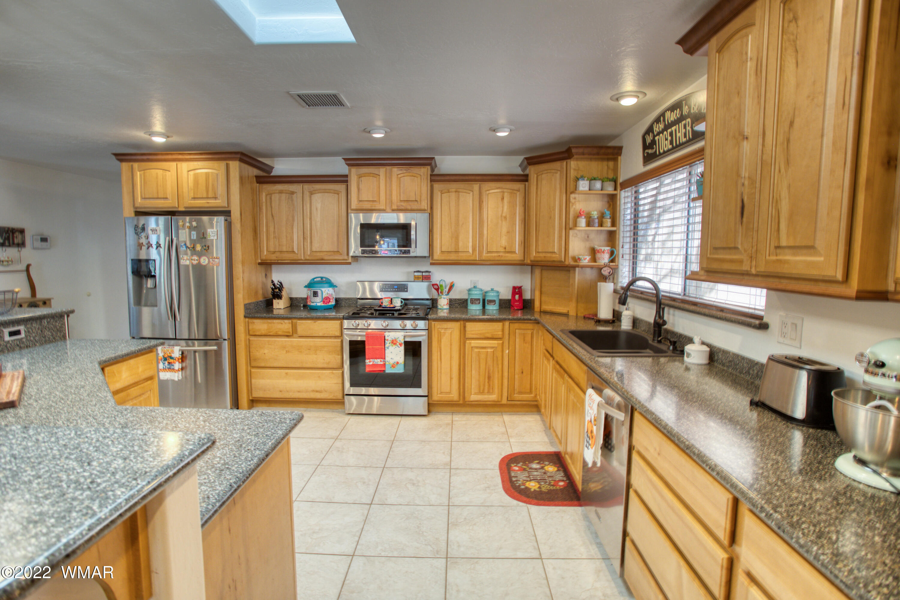 501 West 7th S Street Snowflake, AZ 85937 - Photo 6 of 33 a kitchen with stainless steel appliances granite countertop a sink a stove and a wooden cabinets