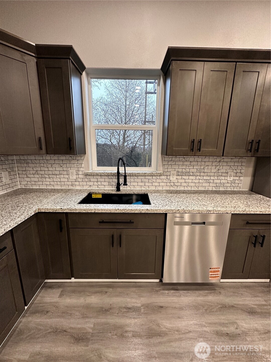 430 East Curtis Street Aberdeen, WA 98520 - Photo 12 of 30 a kitchen with granite countertop a sink cabinets and wooden floor