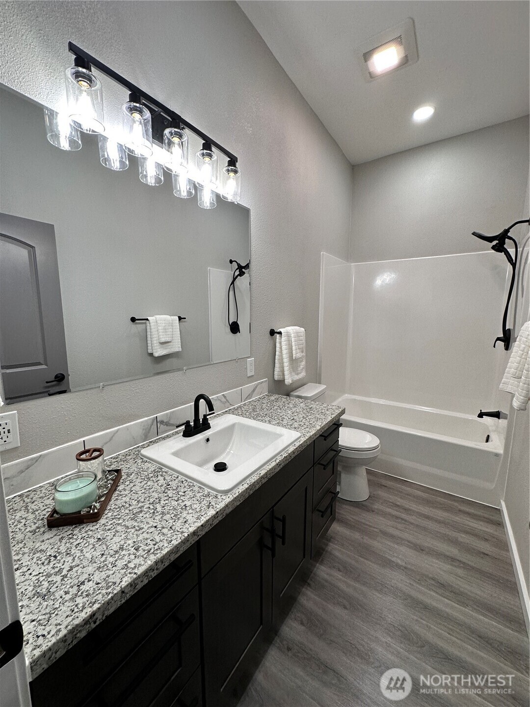 430 East Curtis Street Aberdeen, WA 98520 - Photo 26 of 30 a bathroom with a granite countertop sink a toilet and a mirror