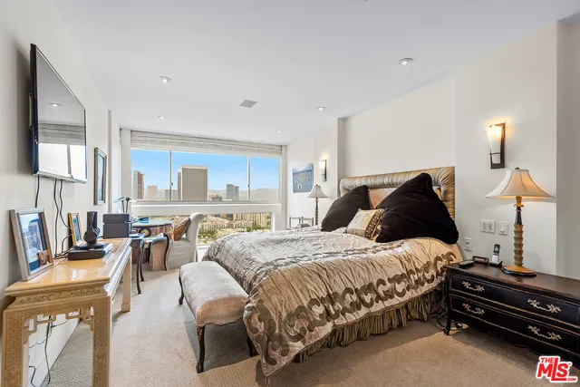 a bedroom with a bed and lamp