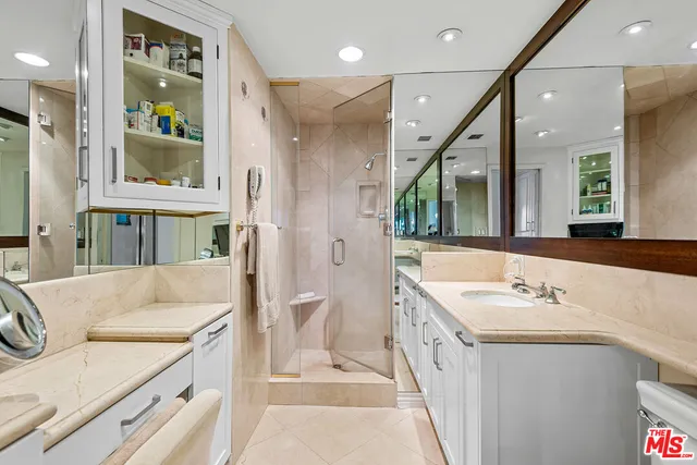 a spacious bathroom with a double vanity sink a mirror and a bathtub