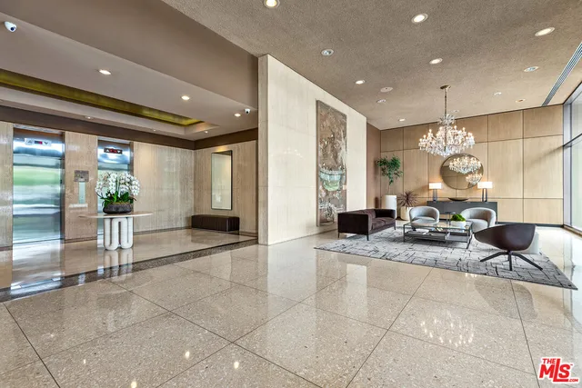 a living room with couches and a potted plant