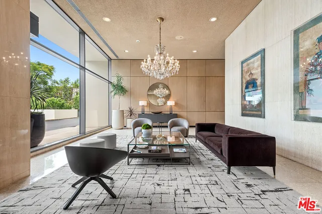a living room with furniture and a chandelier