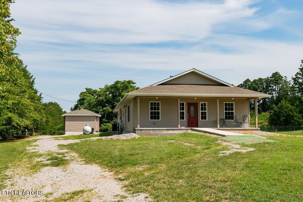 1518 Cummingsville And Sparkman Road Doyle, TN 38559 - Photo 40 of 58 a front view of a house with garden