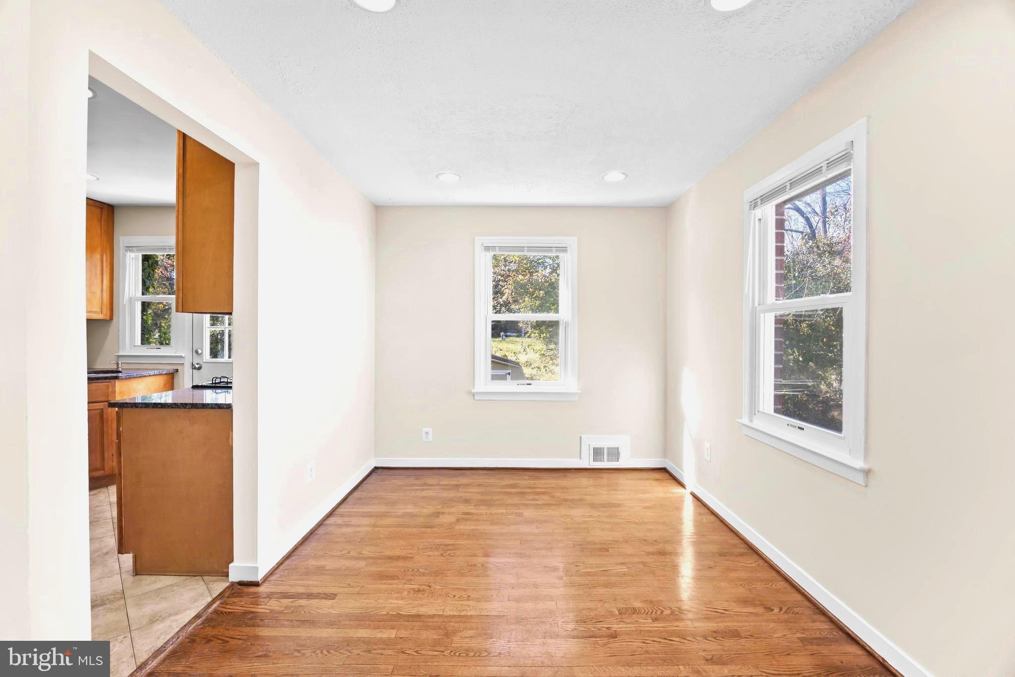 4605 Akron Street Temple Hills, MD 20748 - Photo 10 of 38 a view of an empty room with wooden floor and a window