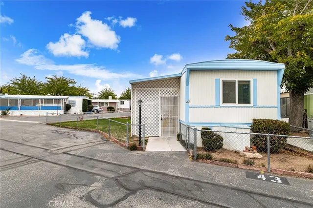 a front view of a house with basket ball court and outdoor seating