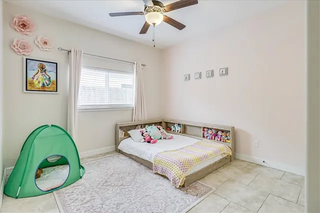a white bed sitting in a bedroom next to a window