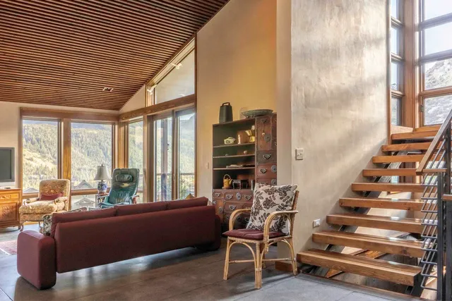 a view of a livingroom with furniture and staircase
