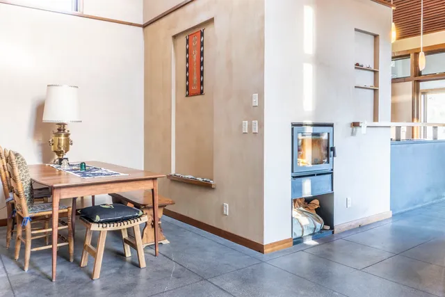 a view of a room that has a table and chairs in it