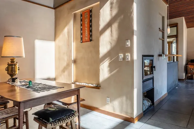 a view of a dining room with furniture and a window