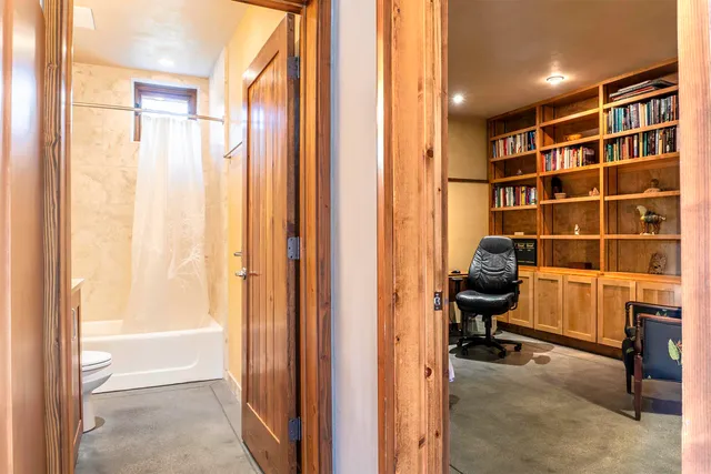 a view of workspace with a window and bathroom