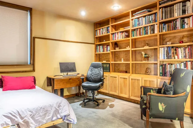 a bedroom with a workspace