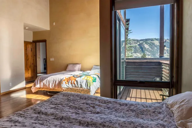 a bed sitting in a bedroom next to a window