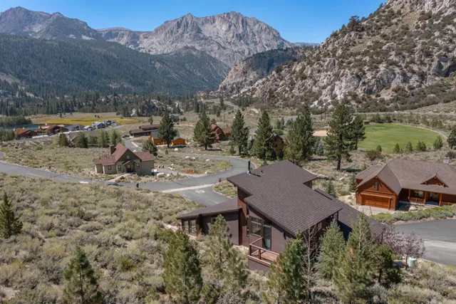 a view of a house with a yard and mountain