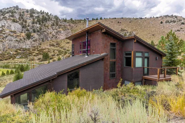 a backyard of a house with table and chairs