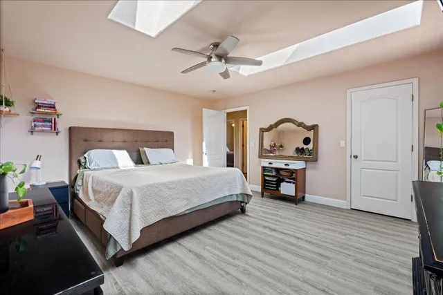 a bedroom with a bed and wooden floor