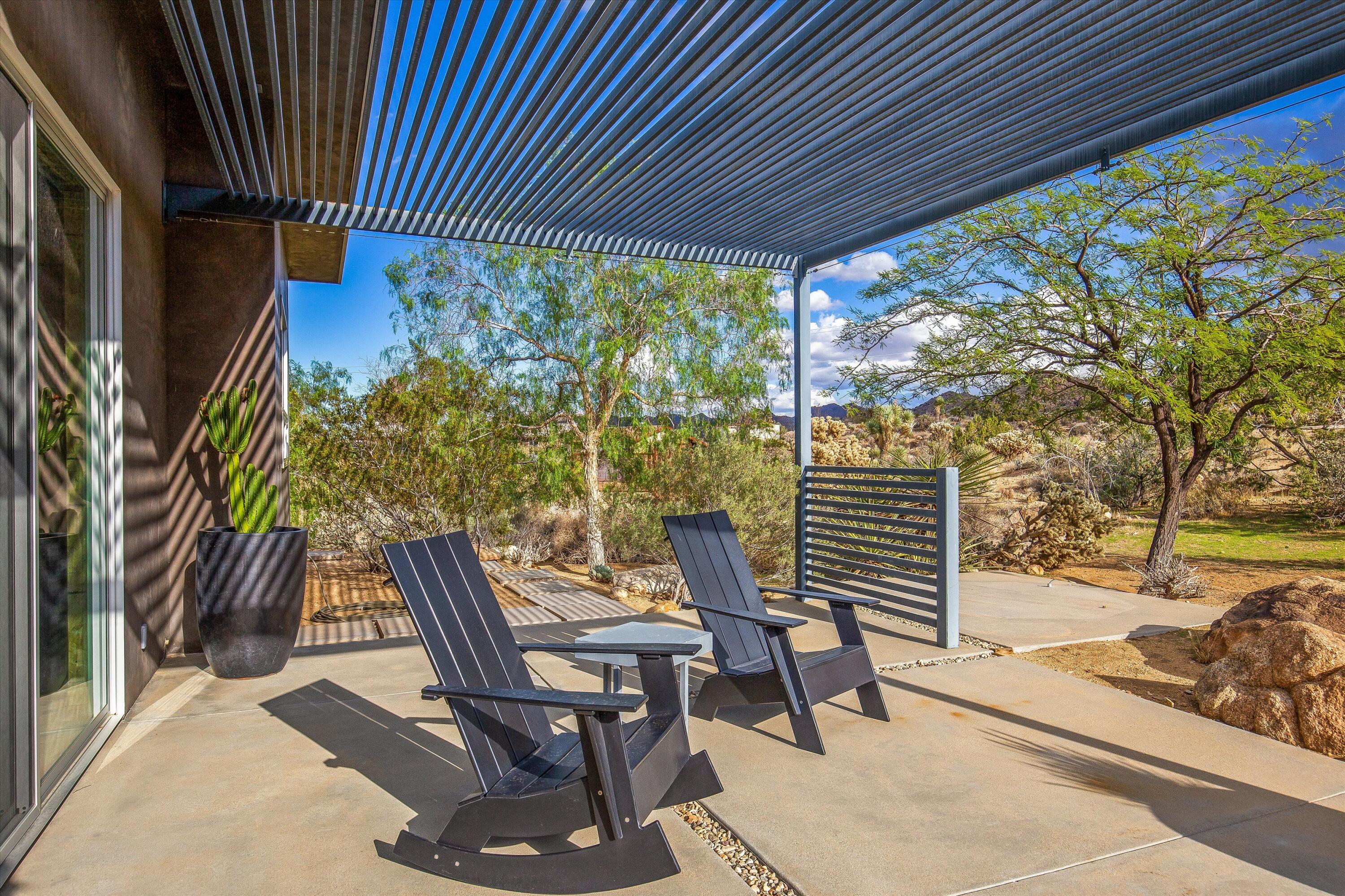 8744 Star Lane Joshua Tree, CA 92252 - Photo 14 of 55 a view of a patio with table and chairs and potted plants