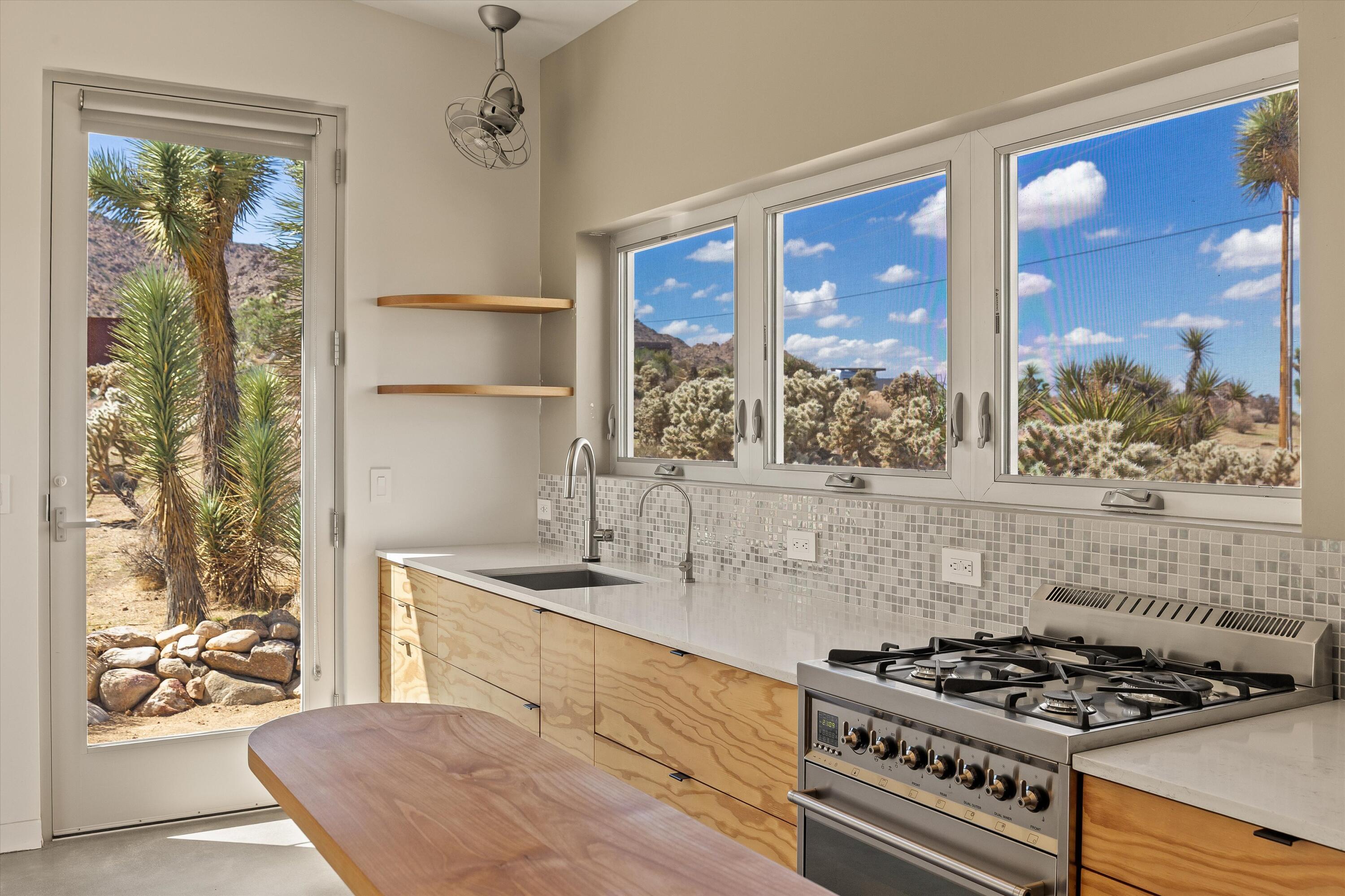 8744 Star Lane Joshua Tree, CA 92252 - Photo 36 of 55 a kitchen with a stove a sink and a window