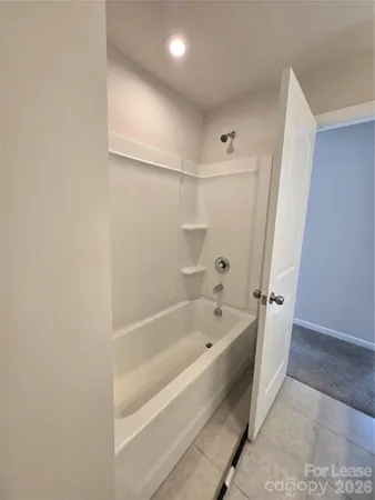 a spacious bathroom with a bathtub and shower