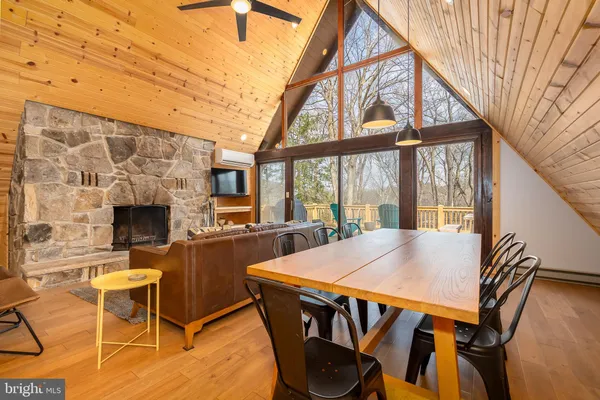 a kitchen with stainless steel appliances granite countertop a refrigerator a sink dishwasher a stove and white countertops with wooden floor