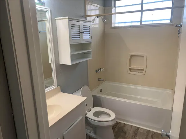 a bathroom with a sink a toilet and a bathtub