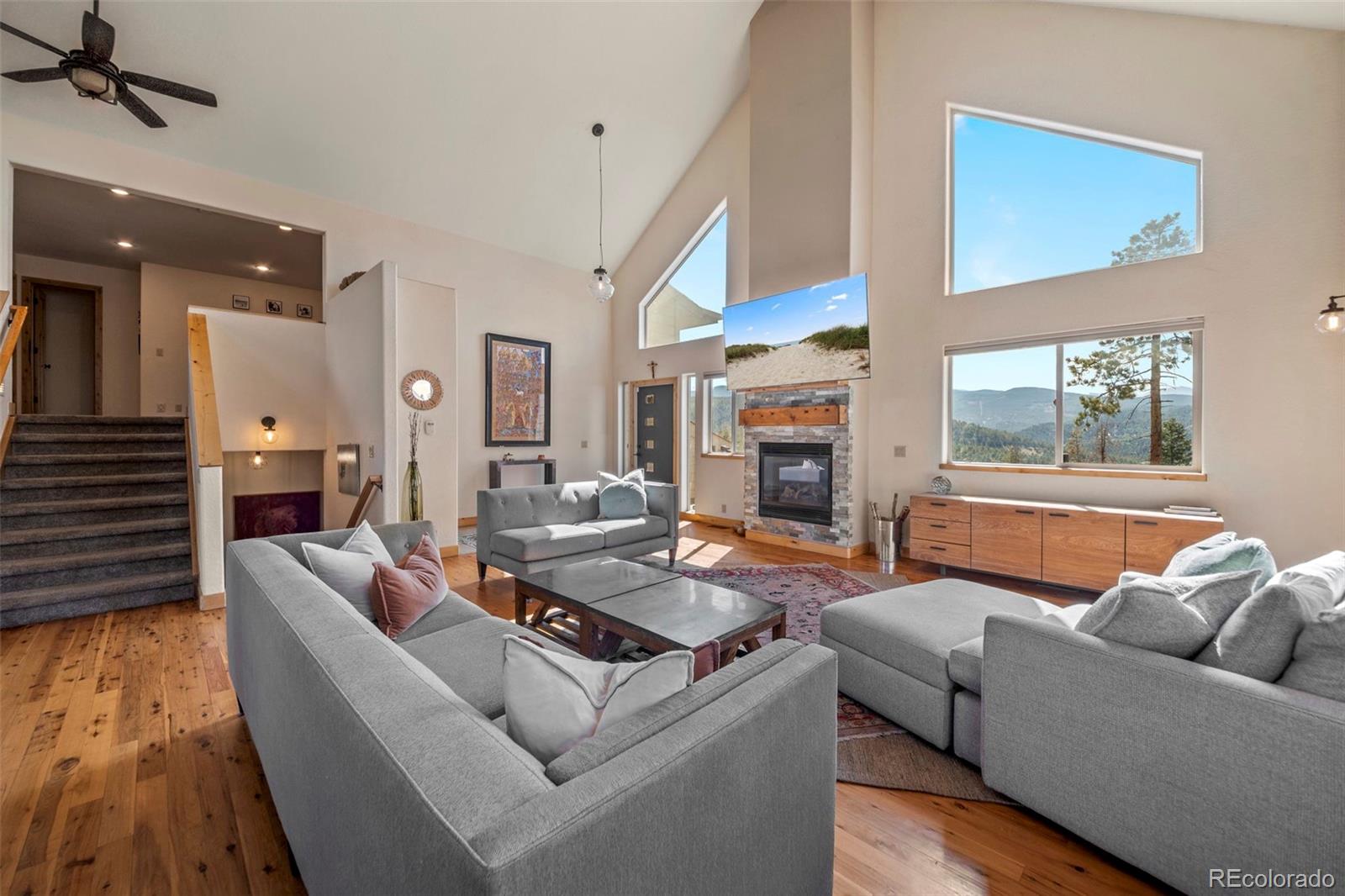 a living room with furniture and a fireplace