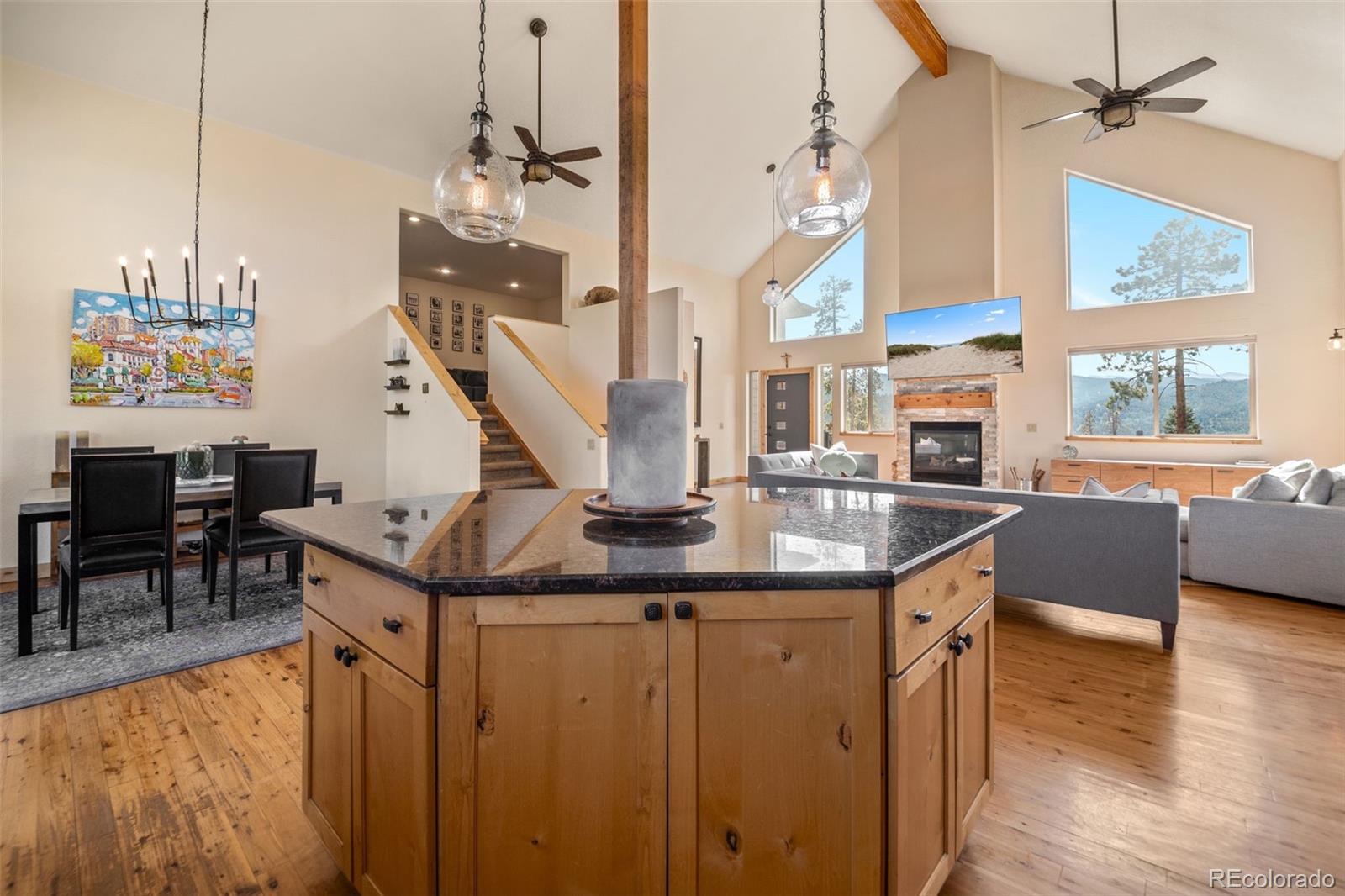 7102 Lynx Lair Road Evergreen, CO 80439 - Photo 11 of 42 a kitchen with stainless steel appliances granite countertop a sink a stove and a wooden floors