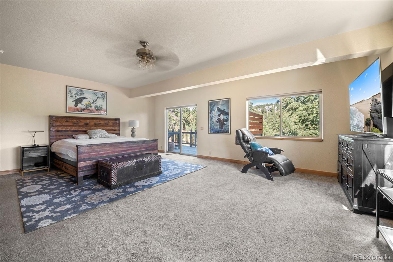7102 Lynx Lair Road Evergreen, CO 80439 - Photo 16 of 42 a bedroom with a bed and a tv on table