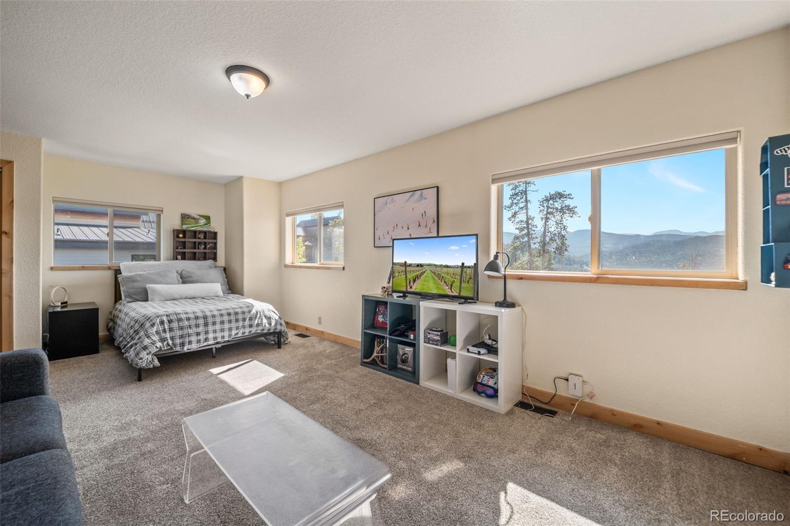 7102 Lynx Lair Road Evergreen, CO 80439 - Photo 19 of 42 a bedroom with a bed and a window