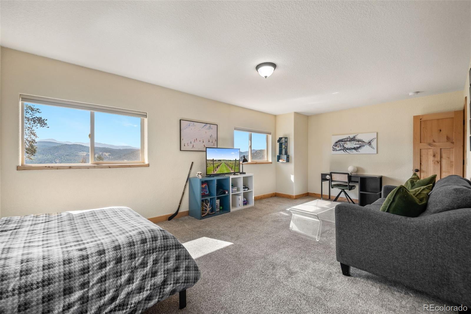 7102 Lynx Lair Road Evergreen, CO 80439 - Photo 20 of 42 a bedroom with a bed and window