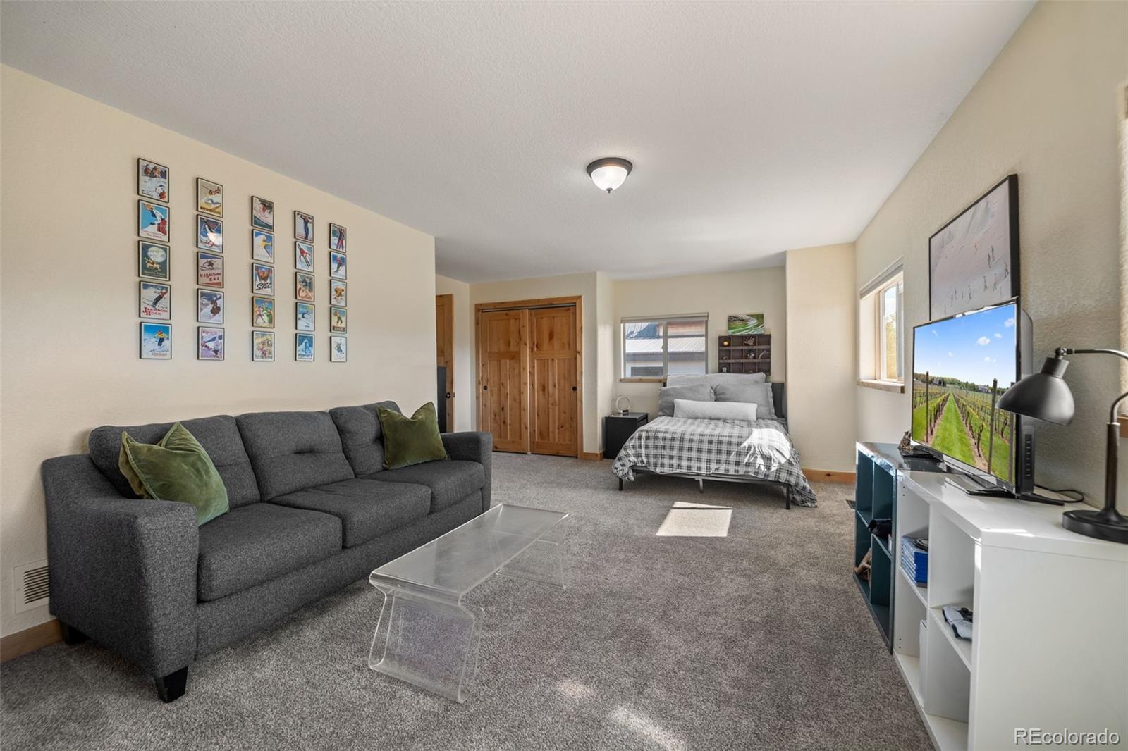 7102 Lynx Lair Road Evergreen, CO 80439 - Photo 21 of 42 a living room with furniture and a flat screen tv
