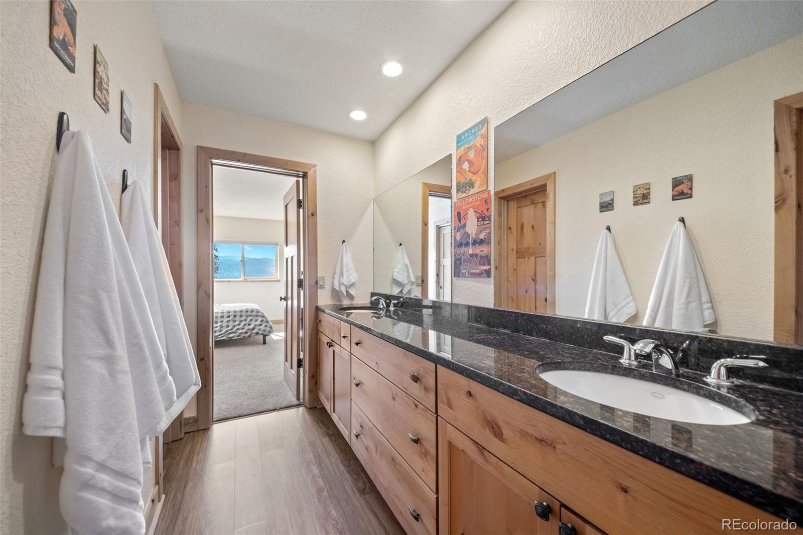 7102 Lynx Lair Road Evergreen, CO 80439 - Photo 22 of 42 a bathroom with a double vanity sink and a mirror