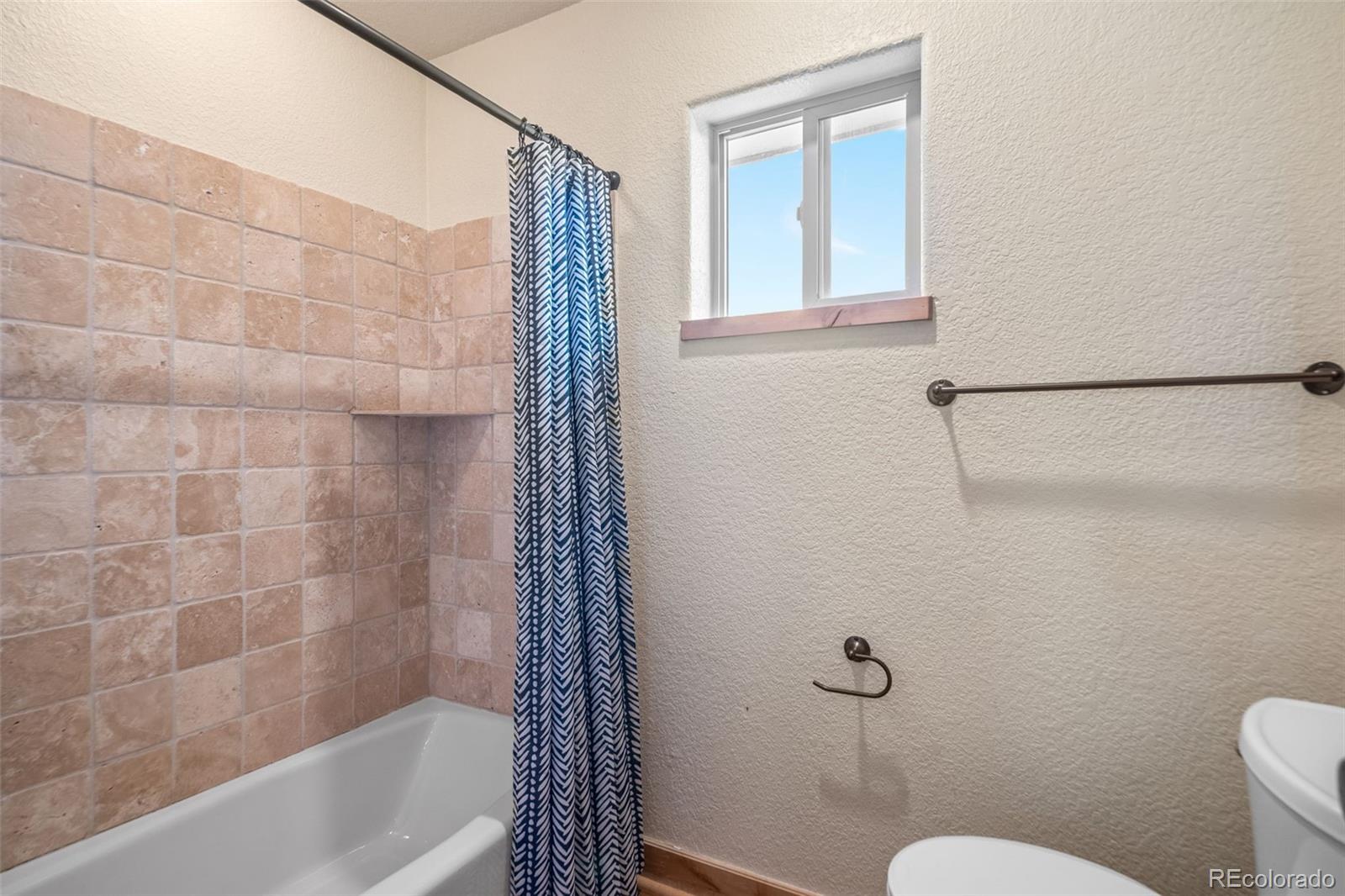 7102 Lynx Lair Road Evergreen, CO 80439 - Photo 25 of 42 a bathroom with a shower a toilet and a sink