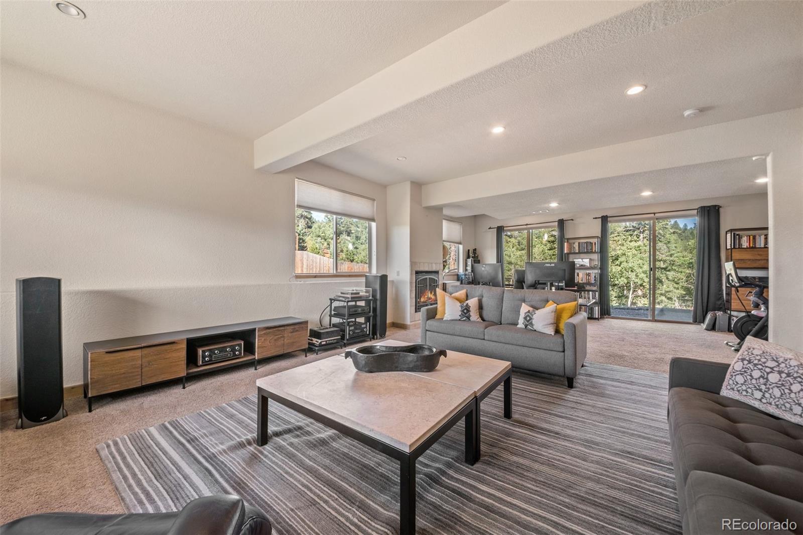 7102 Lynx Lair Road Evergreen, CO 80439 - Photo 27 of 42 a living room with furniture and a wooden floor
