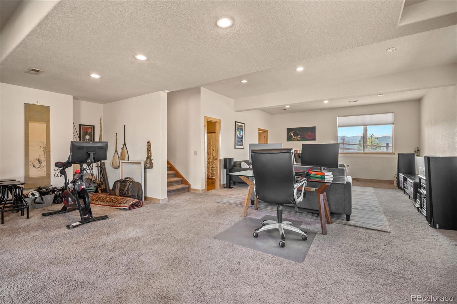 7102 Lynx Lair Road Evergreen, CO 80439 - Photo 28 of 42 a view of a livingroom with workspace and a couch