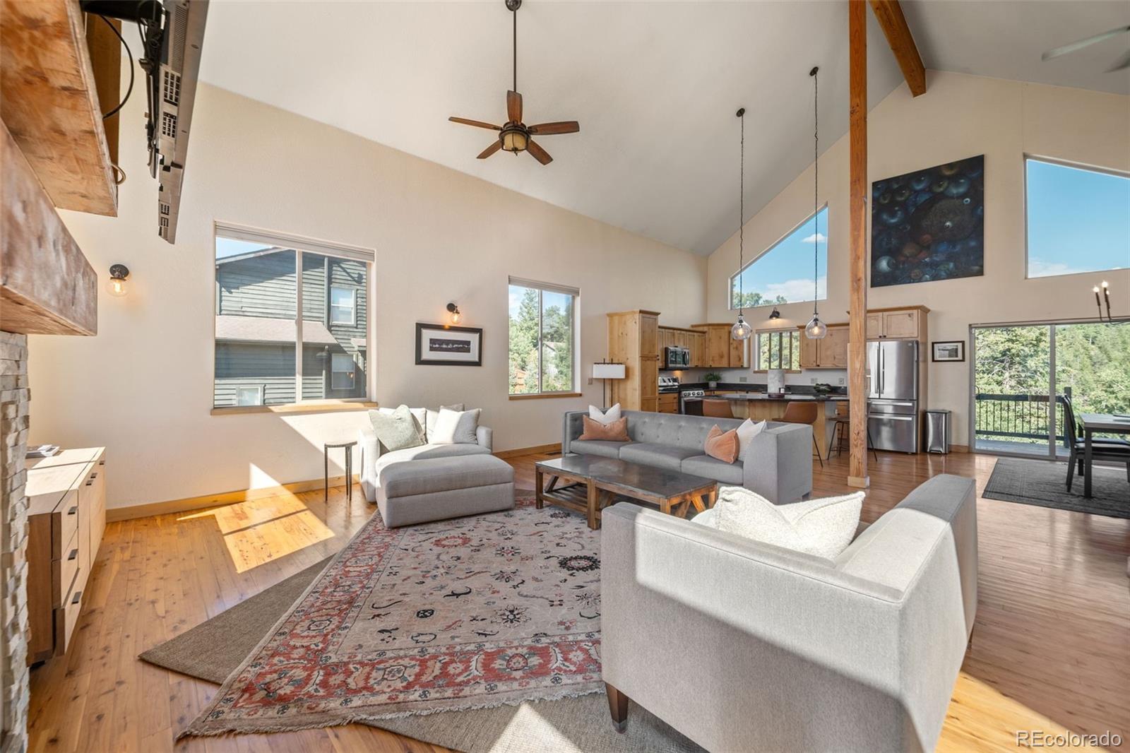 7102 Lynx Lair Road Evergreen, CO 80439 - Photo 3 of 42 a living room with furniture wooden floor and a large window