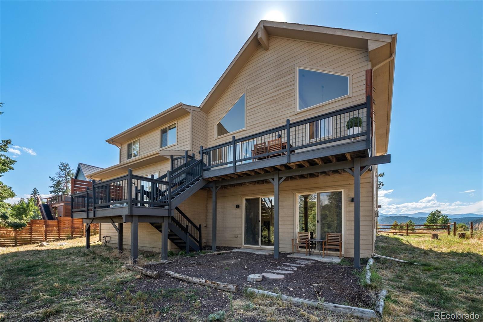 7102 Lynx Lair Road Evergreen, CO 80439 - Photo 33 of 42 a front view of a house with a yard