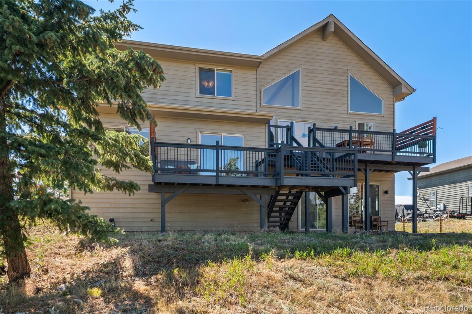 7102 Lynx Lair Road Evergreen, CO 80439 - Photo 34 of 42 a view of a house with a yard