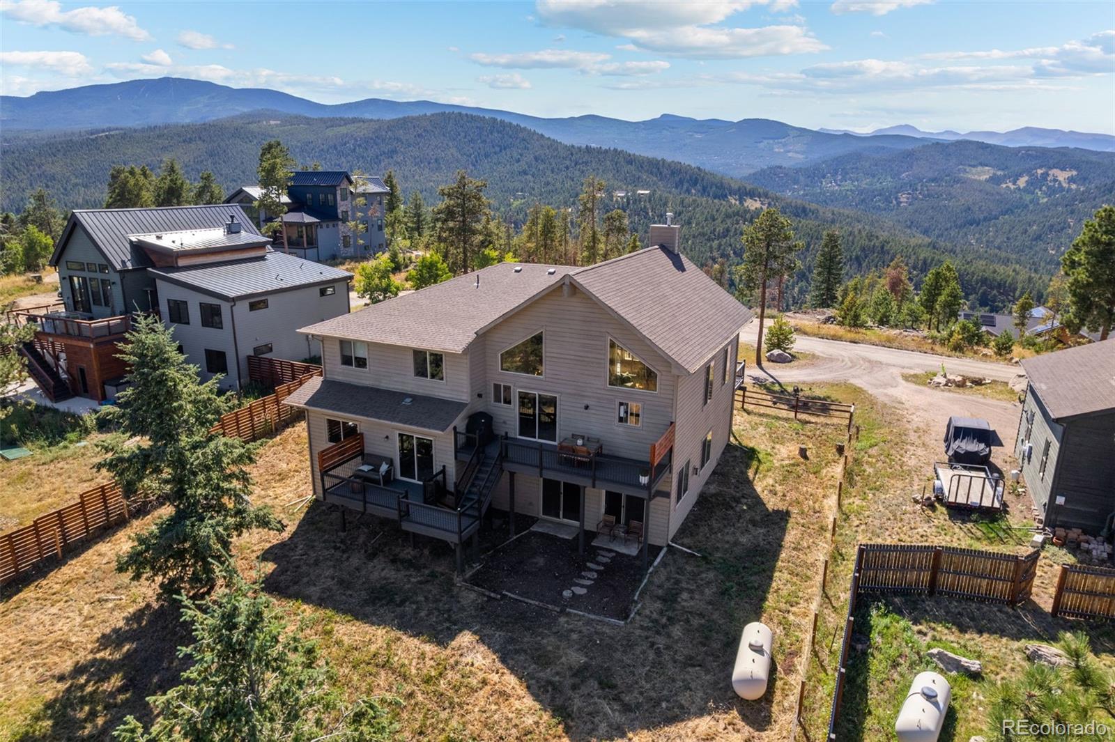 7102 Lynx Lair Road Evergreen, CO 80439 - Photo 36 of 42 an aerial view of residential houses with a yard and mountain view