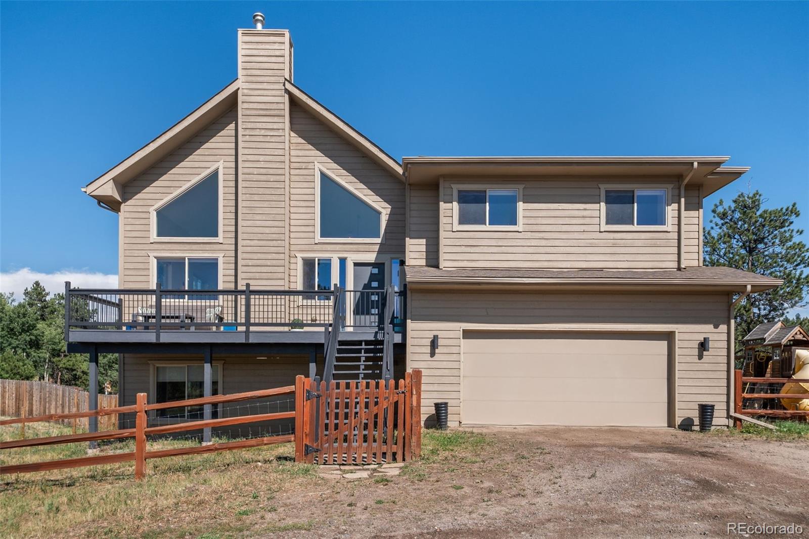 7102 Lynx Lair Road Evergreen, CO 80439 - Photo 38 of 42 a front view of a house with a garage