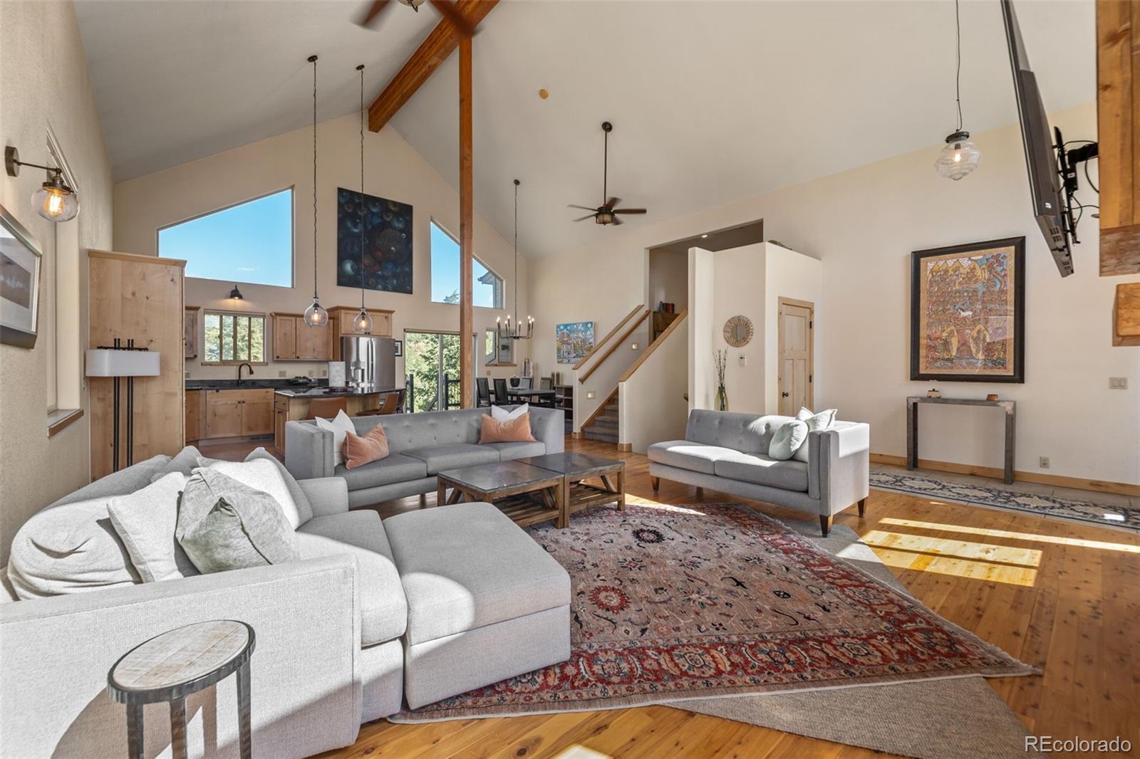 7102 Lynx Lair Road Evergreen, CO 80439 - Photo 4 of 42 a living room with furniture fireplace and a rug