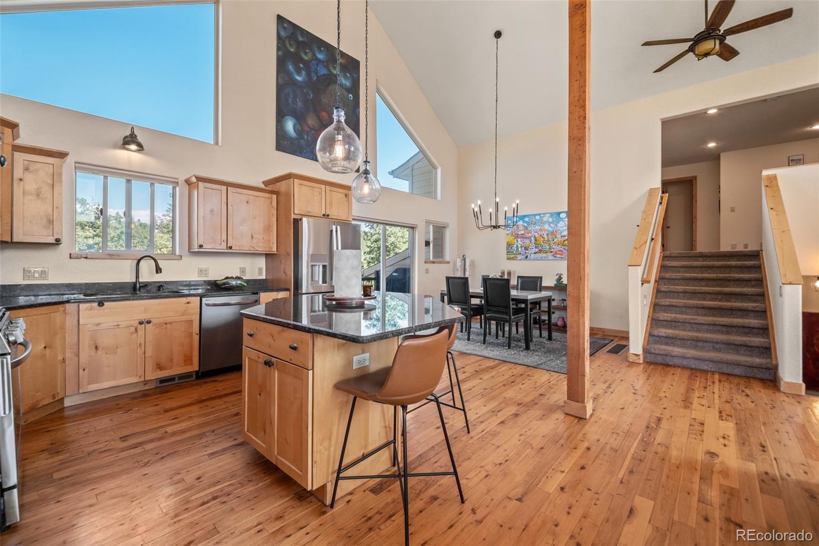 7102 Lynx Lair Road Evergreen, CO 80439 - Photo 10 of 42 a kitchen with stainless steel appliances granite countertop wooden floors and sink