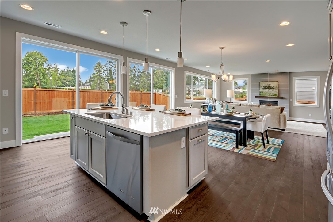 322 Field Place Southeast Renton, WA 98059 - Photo 7 of 25 a kitchen with a sink stove and wooden floor