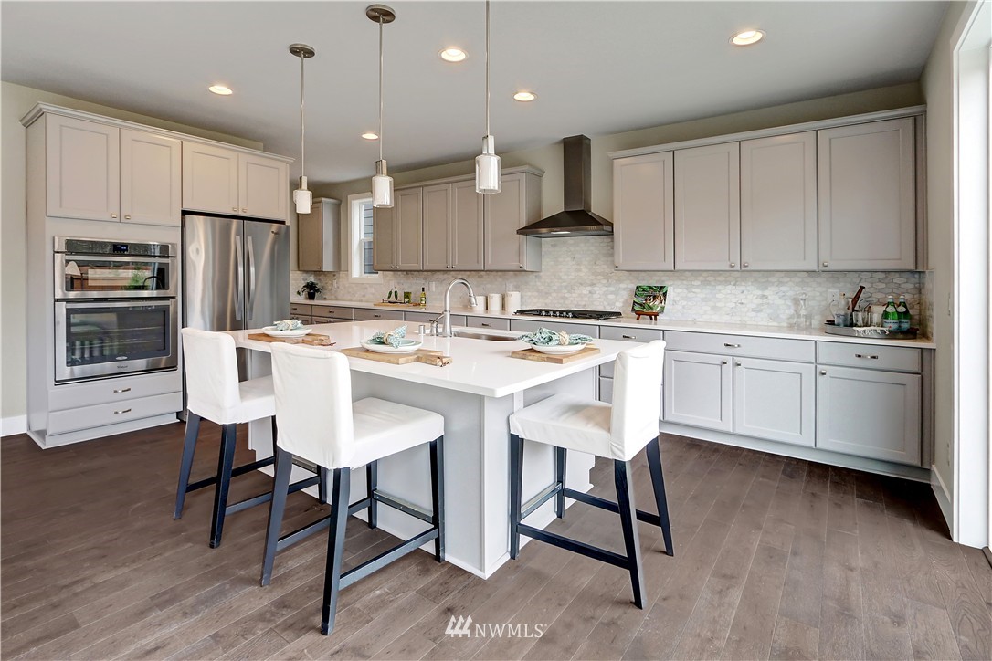 322 Field Place Southeast Renton, WA 98059 - Photo 9 of 25 a kitchen with a sink a microwave a refrigerator and white cabinets