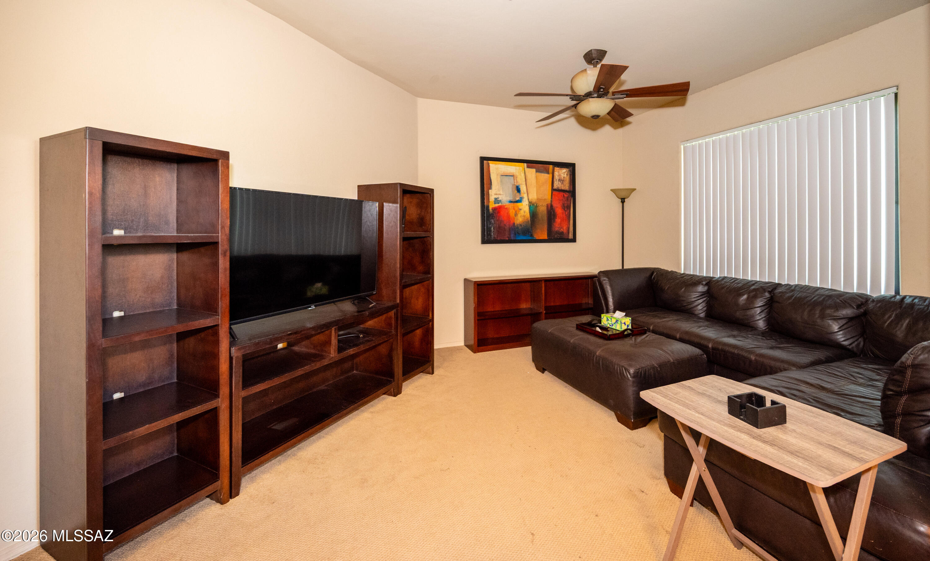 2550 East River Road, Unit 15303 Tucson, AZ 85718 - Photo 10 of 15 a living room with furniture and a flat screen tv