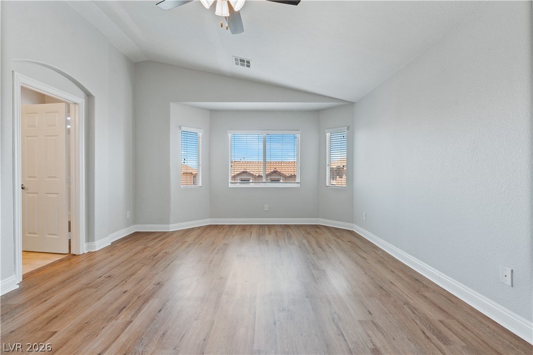 1328 Spice Ridge Court Henderson, NV 89012 - Photo 22 of 51 This spacious Primary bedroom offers ample natural light and durable flooring for comfortable living.